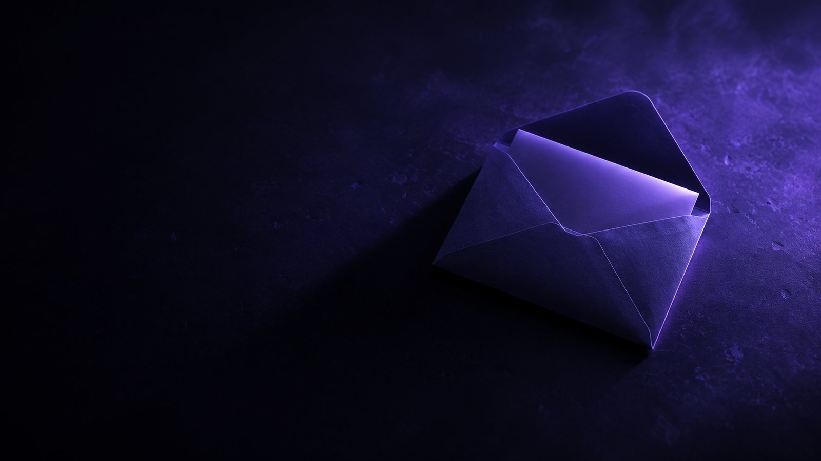 An opened envelope on a dark desk, lit in cold purple