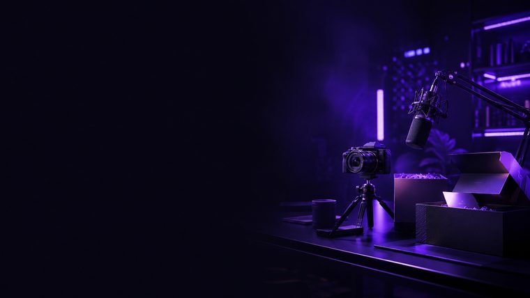 A creator&rsquo;s desk lit in purple