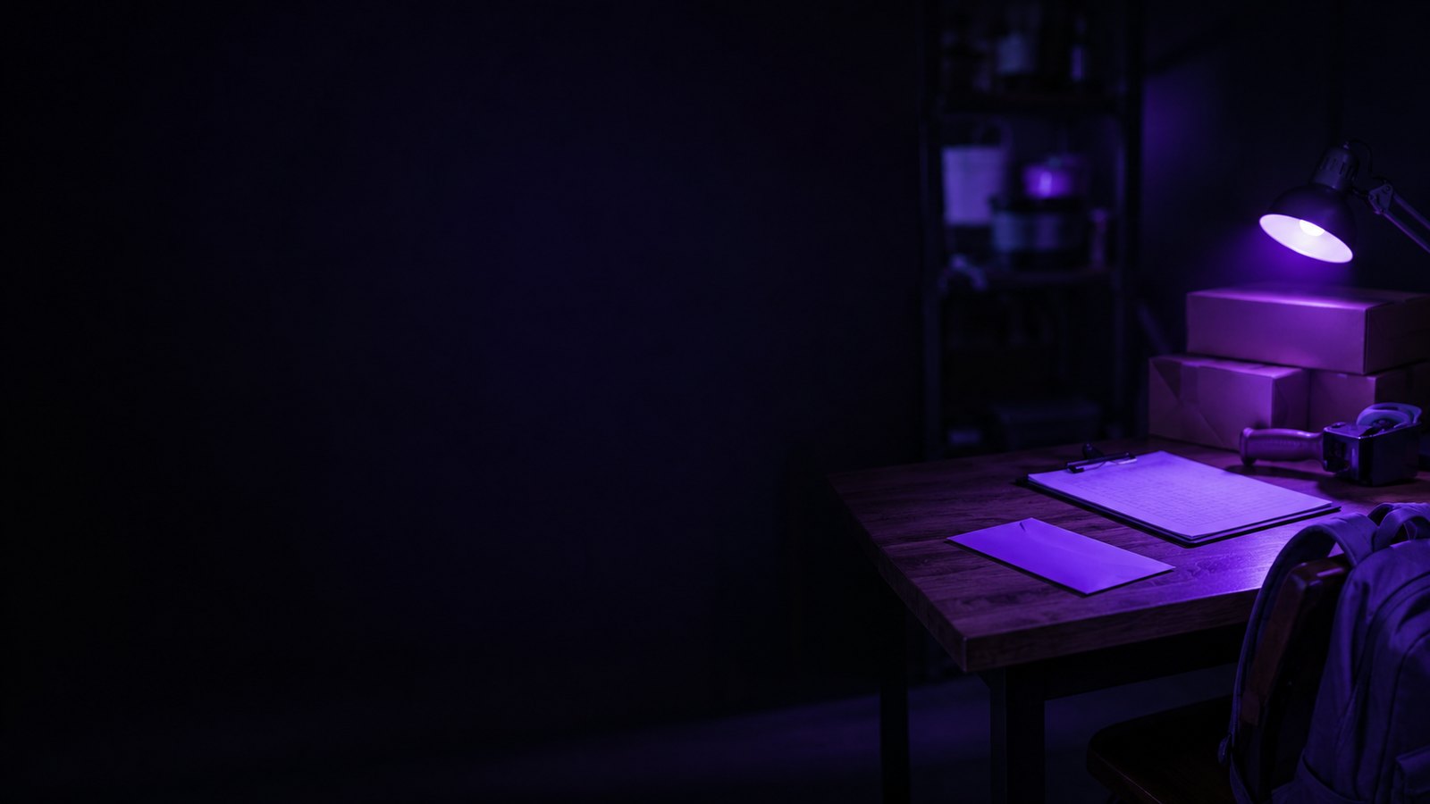 A young worker&rsquo;s desk in a family business, lit in purple